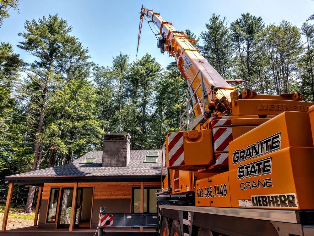 Granite State Crane Liebherr crane working beside a house